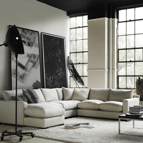large white sectional sofa with floor lamp in modern loft